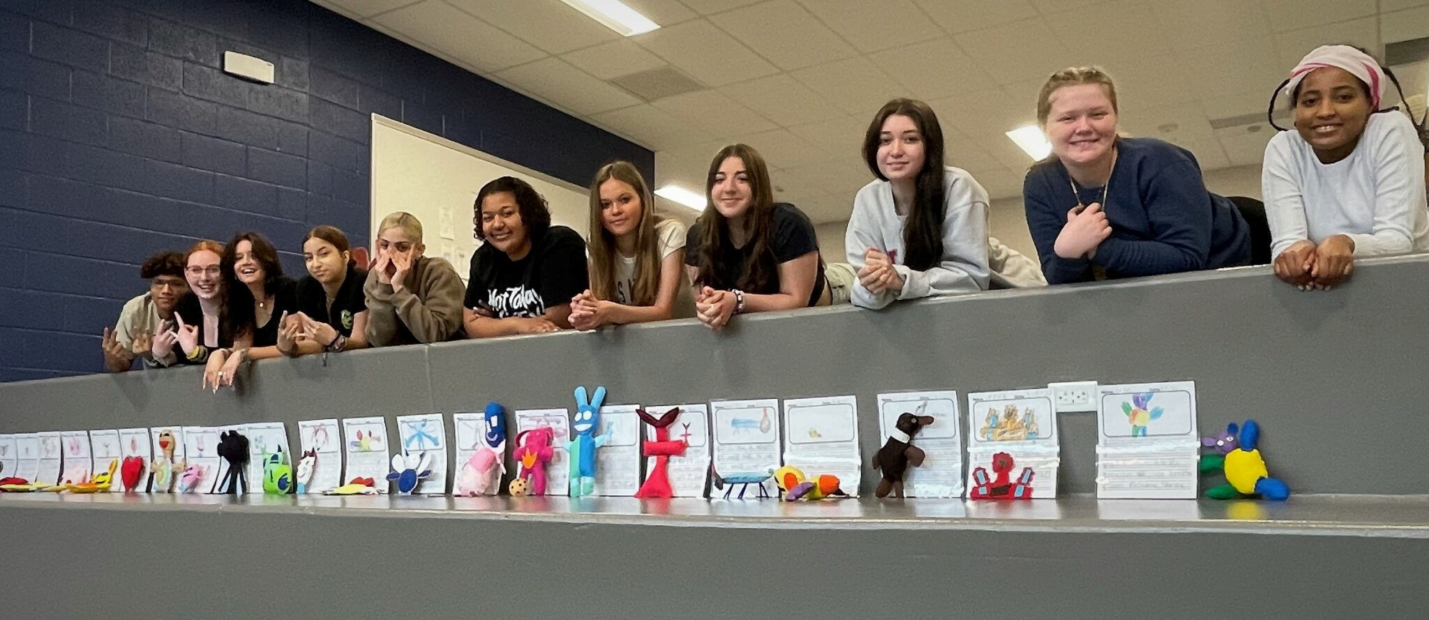 Photo of fashion design students with their creations
