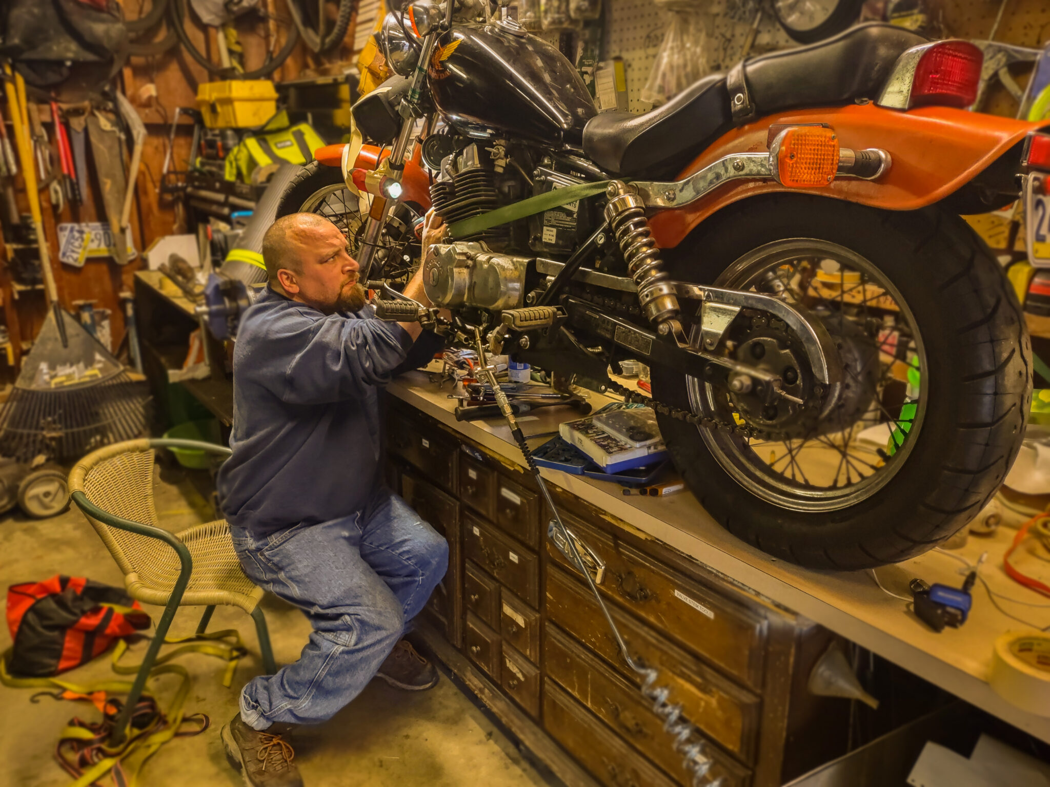 Photo of a man working on a motorcycle