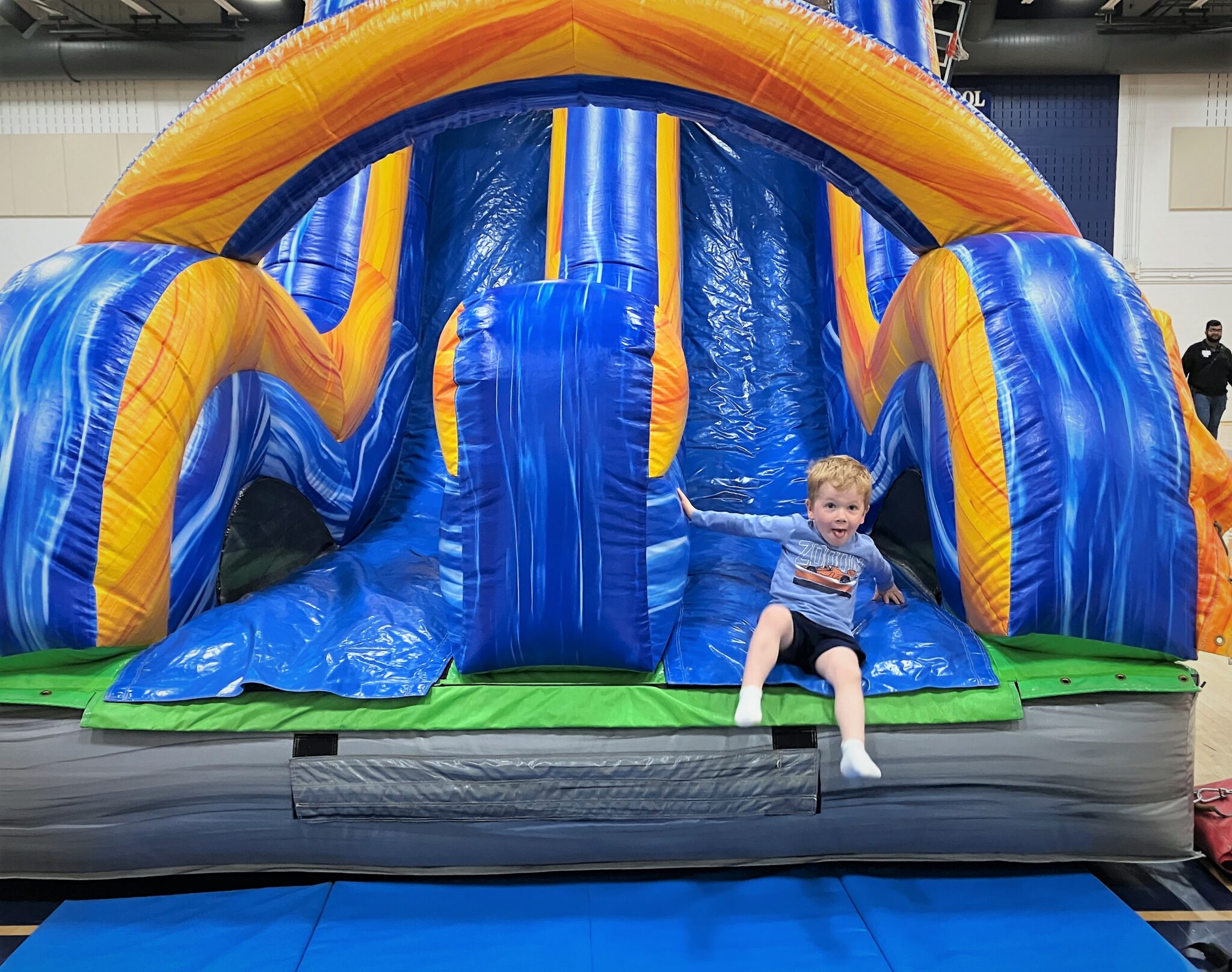 Photo of a young boy on a inflatable slide.