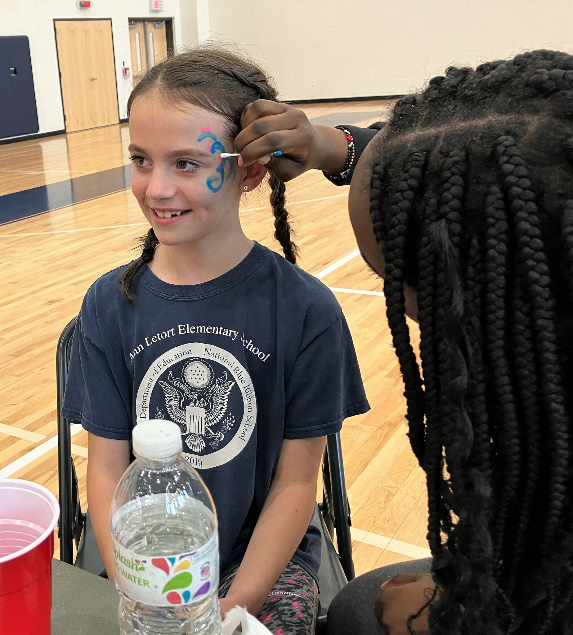 Photo of a girl getting her face painted.