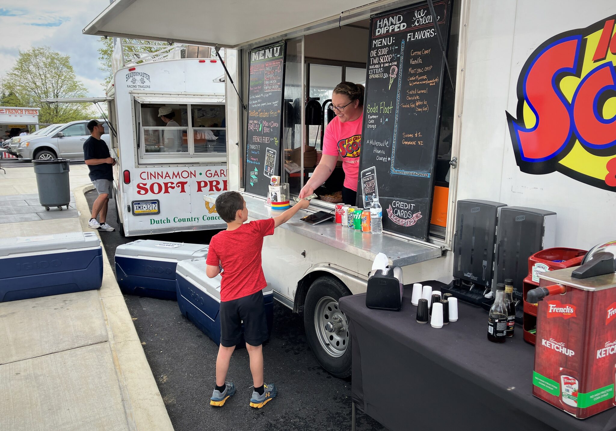 Photo of a boy at a food truck outside the high school.