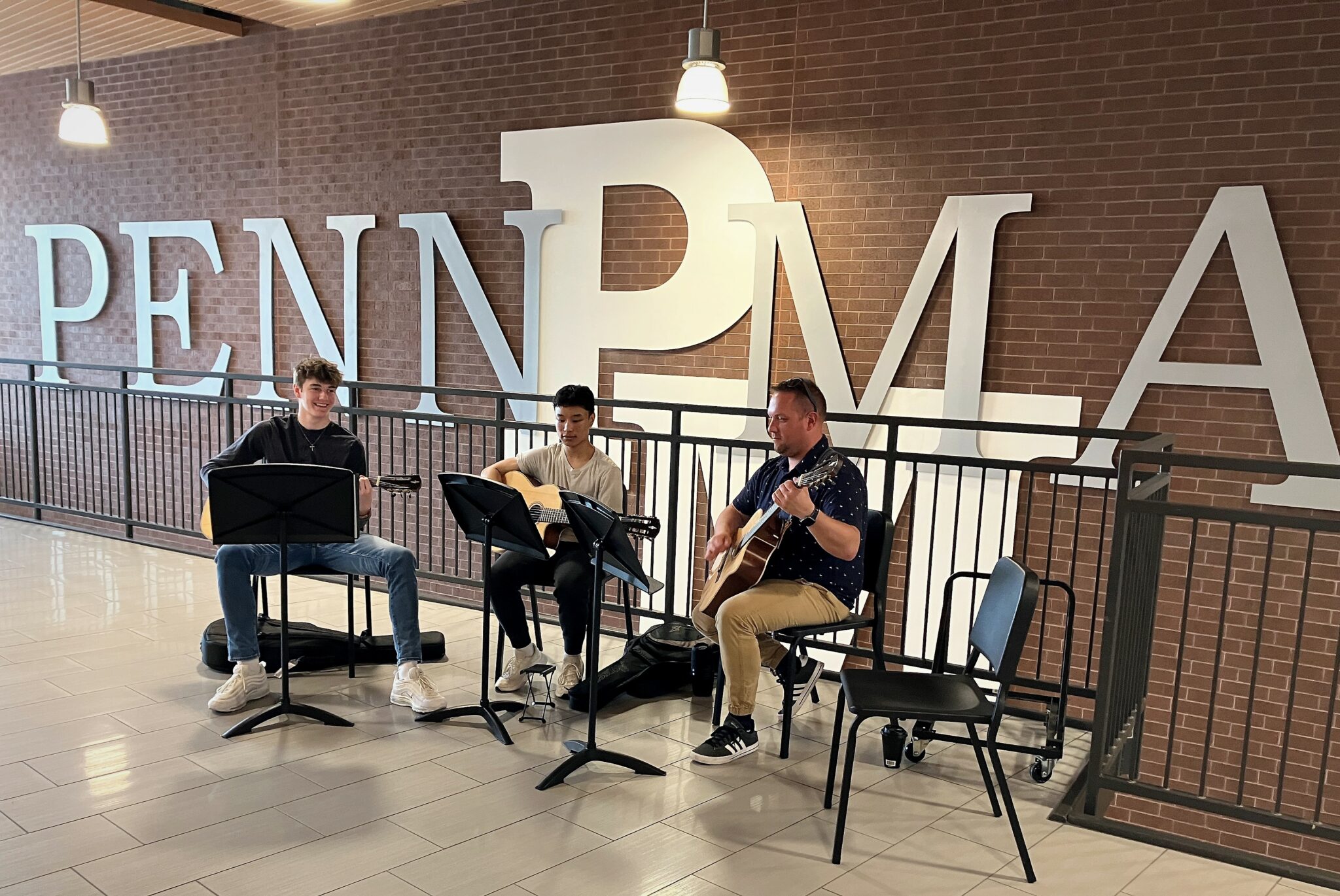 Photo of three musicians performing in the corridor of Penn Manor High School.
