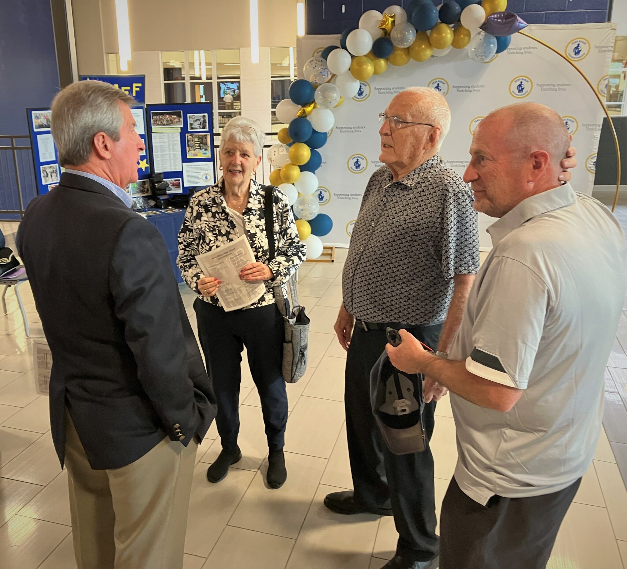 Photo of four people attending the dedication ceremony.