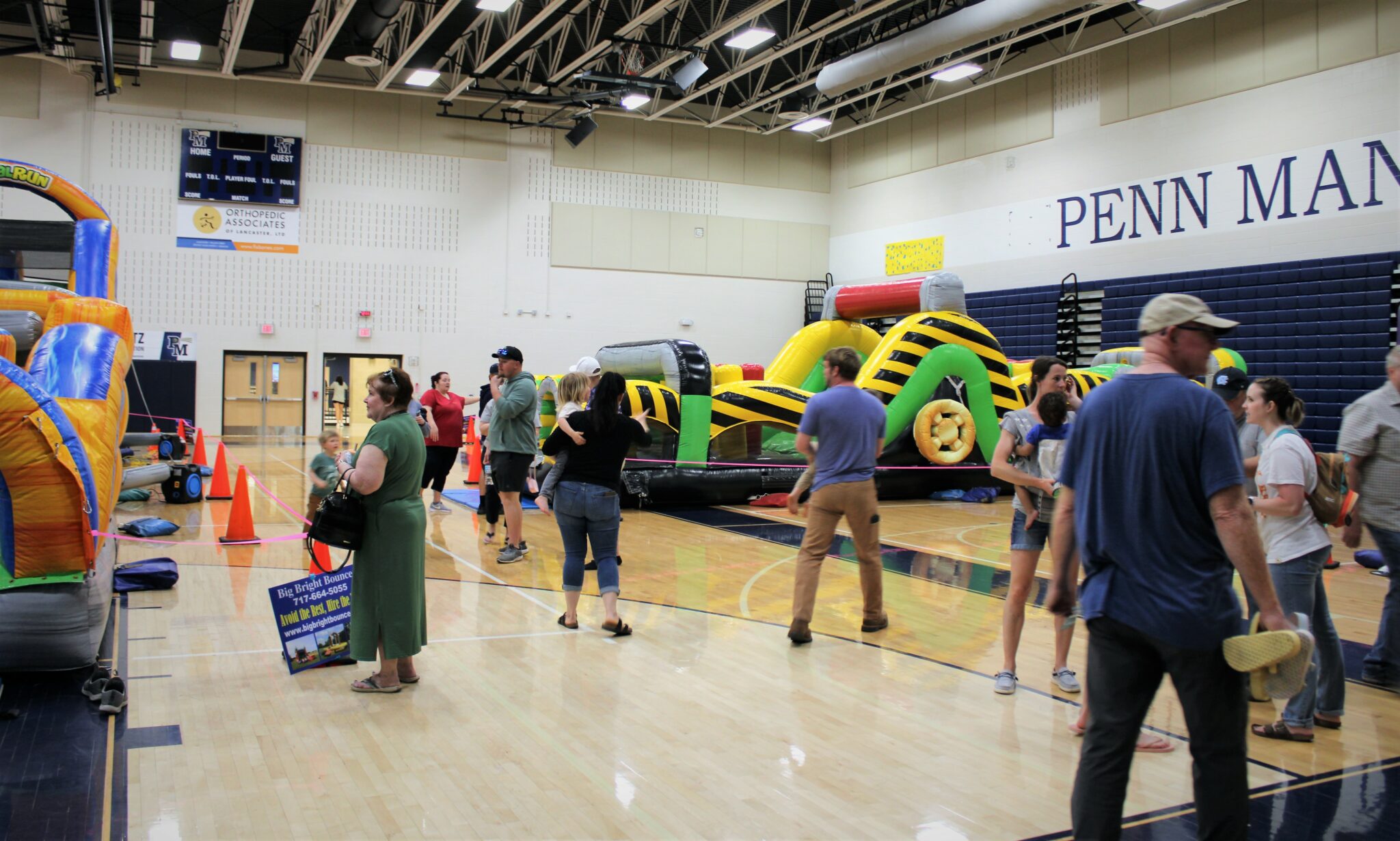 Photo of several people gathering in the high school gymnasium for the Penn Manor Community Fest.