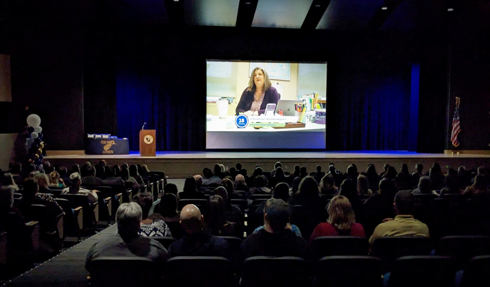 Phot of the auditorium as the retiree video plays.