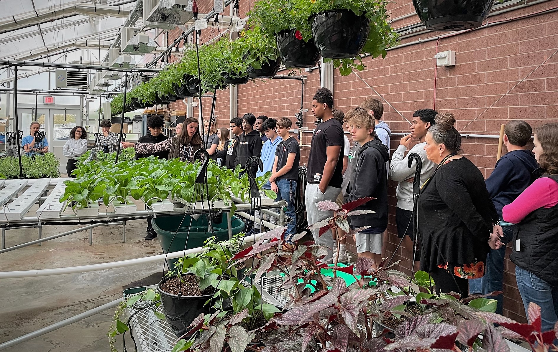 A group of students in the greenhouse.