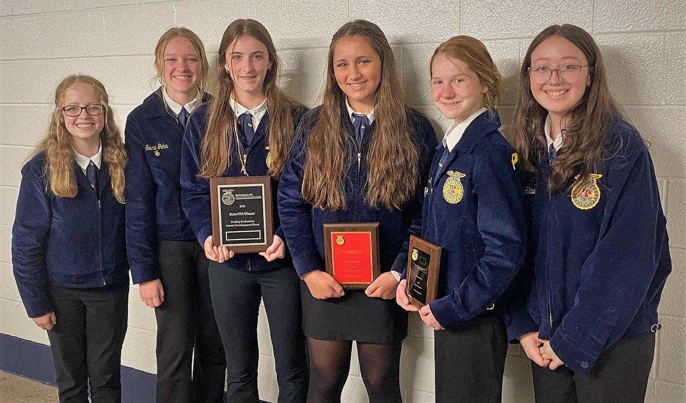 Photo of six students who are on the Poultry Evaluation Team holding two awards.